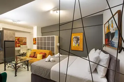 a bedroom with a bed and a living room at Urban Art Suites in Athens
