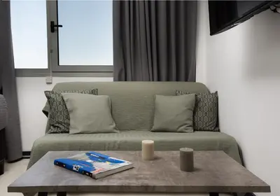 a living room with a couch and a table at Urban Art Suites in Athens