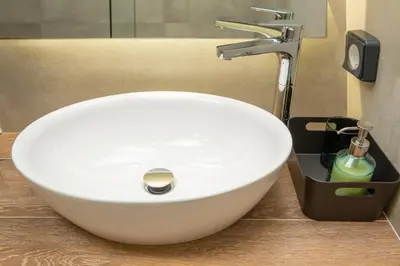 a white sink in a bathroom with a faucet at Urban Art Suites in Athens