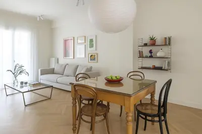 a living room with a table and chairs and a couch at Athenian Vintage Apartment in Athens