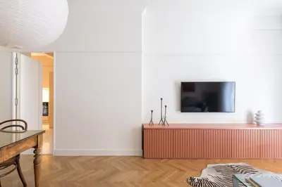 a living room with a tv on a wall at Athenian Vintage Apartment in Athens