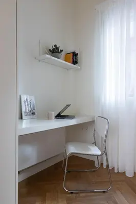 a white desk with a chair in a room at Athenian Vintage Apartment in Athens