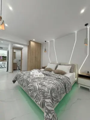 a bedroom with a large bed with a zebra print blanket at Smart Athens Stay, Studio Near Acropolis & Metro in Athens