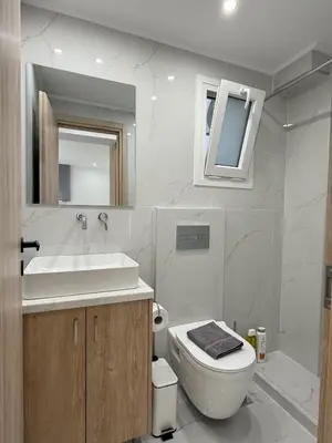 a white bathroom with a sink and a toilet at Smart Athens Stay, Studio Near Acropolis & Metro in Athens