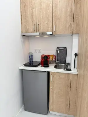 a small kitchen with a sink and a microwave at Smart Athens Stay, Studio Near Acropolis & Metro in Athens