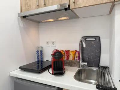 a kitchen counter with a sink and a kitchen appliance at Smart Athens Stay, Studio Near Acropolis & Metro in Athens