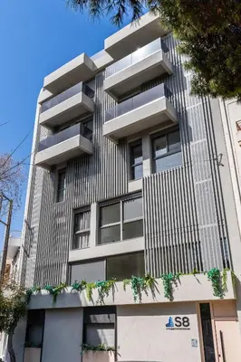 a tall building with balconies on the side of it at Acropolis View - Stylish City Penthouse with Large Terrace in Athens