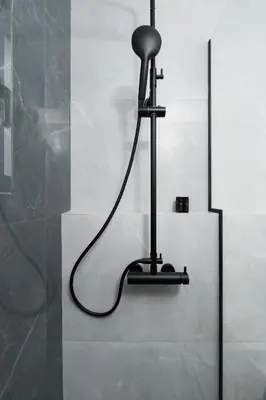a black light hanging from a wall in a bathroom at Acropolis View - Stylish City Penthouse with Large Terrace in Athens