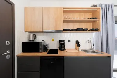 a kitchen counter with a microwave and a sink at Acropolis View - Stylish City Penthouse with Large Terrace in Athens