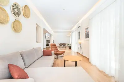 a living room with a couch and a table at Spacious apt with 2 beds and 2 baths in Pagrati in Athens