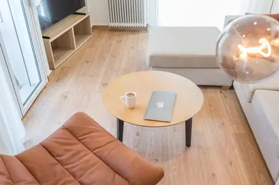 a coffee table with a laptop on it in a living room at Spacious apt with 2 beds and 2 baths in Pagrati in Athens