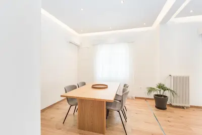 a conference room with a wooden table and chairs at Spacious apt with 2 beds and 2 baths in Pagrati in Athens