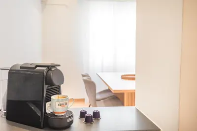 a coffee maker and a coffee cup on a table at Spacious apt with 2 beds and 2 baths in Pagrati in Athens