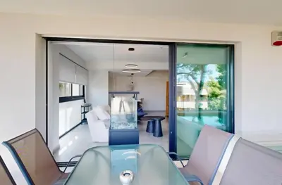 a glass table and chairs in a room with a view at Κ2 Varkiza Seaside Residences in Vari