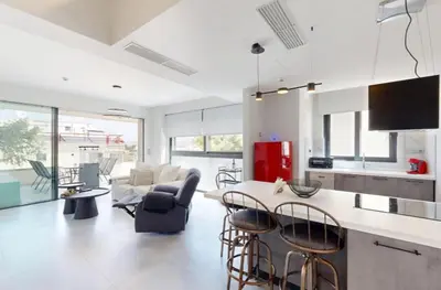 a kitchen and living room with a table and chairs at Κ2 Varkiza Seaside Residences in Vari