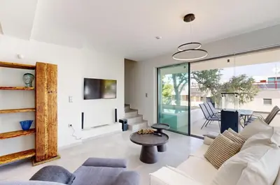 a living room with a couch and a table at Κ2 Varkiza Seaside Residences in Vari