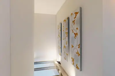 a hallway with three paintings on the wall at Κ2 Varkiza Seaside Residences in Vari