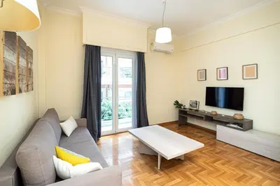 a living room with a couch and a tv at Casa Del Guerriero, Athens in Athens