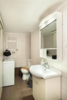 a bathroom with a sink and a toilet and a mirror at Casa Del Guerriero, Athens in Athens