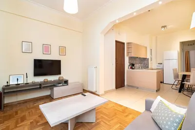 a living room with a couch and a tv at Casa Del Guerriero, Athens in Athens