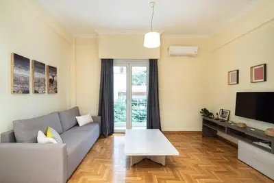 a living room with a couch and a tv at Casa Del Guerriero, Athens in Athens