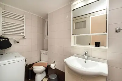 a white bathroom with a sink and a toilet at Casa Del Guerriero, Athens in Athens