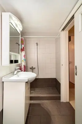 a bathroom with a sink and a shower at Casa Del Guerriero, Athens in Athens