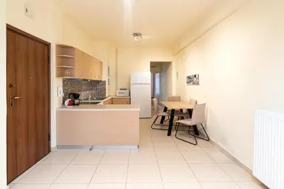 a kitchen with a counter and a table and a refrigerator at Casa Del Guerriero, Athens in Athens