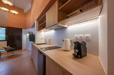 a kitchen with a counter with a coffee maker on it at AthenianNest Sarri Boutique Studios Psyrri in Athens