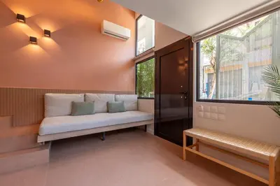 a living room with a couch and a window at AthenianNest Sarri Boutique Studios Psyrri in Athens