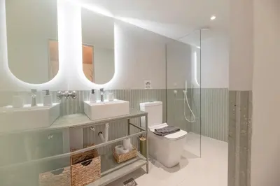 a bathroom with a toilet and a sink and a mirror at AthenianNest Sarri Boutique Studios Psyrri in Athens