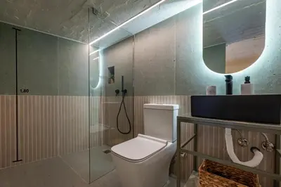 a bathroom with a toilet and a glass shower at AthenianNest Sarri Boutique Studios Psyrri in Athens
