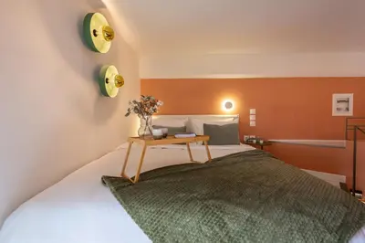 a bedroom with a bed with a table on it at AthenianNest Sarri Boutique Studios Psyrri in Athens
