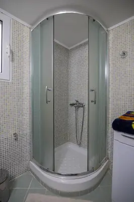 a shower with a glass door in a bathroom at CitySoul Athens in Athens