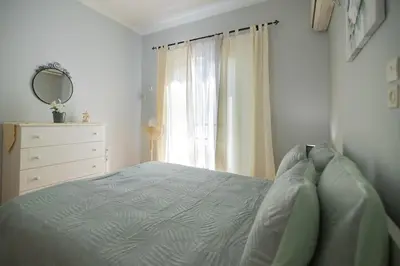 a bedroom with a bed and a dresser and a mirror at CitySoul Athens in Athens