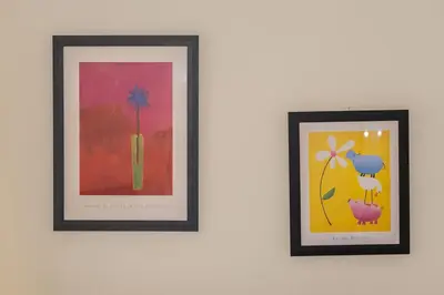 two framed pictures of flowers on a wall at CitySoul Athens in Athens
