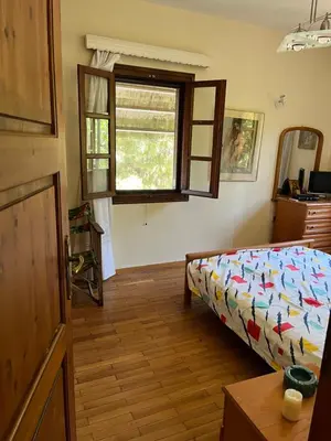 a bedroom with a bed and a window at Lagonisi 1 in Kalívia Thorikoú
