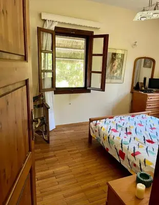 a bedroom with a bed and a window at Lagonisi 1 in Kalívia Thorikoú