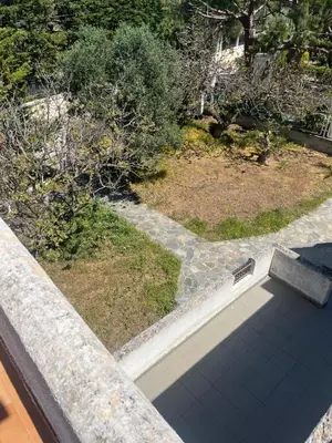 an overhead view of a garden with a bench on a balcony at Lagonisi 1 in Kalívia Thorikoú