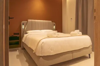 a bedroom with a large white bed with towels on it at Athens apartment near city centre in Athens