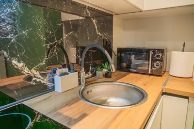 a bathroom with a sink and a microwave at Athens apartment near city centre in Athens
