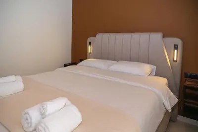 a bedroom with a large white bed with towels on it at Athens apartment near city centre in Athens