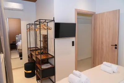 a mirror in a room with a bed and a bed sidx sidx sidx at Athens apartment near city centre in Athens