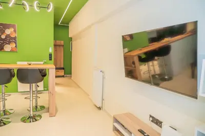a room with a table and a green wall at Athens apartment near city centre in Athens