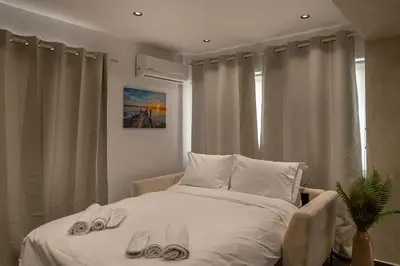 a bedroom with a bed with shoes on it at South Metro Suite in Athens