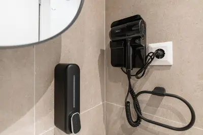 a phone is hanging on a wall in a bathroom at South Metro Suite in Athens