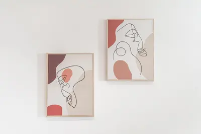 two framed illustrations of people on a wall at South Metro Suite in Athens