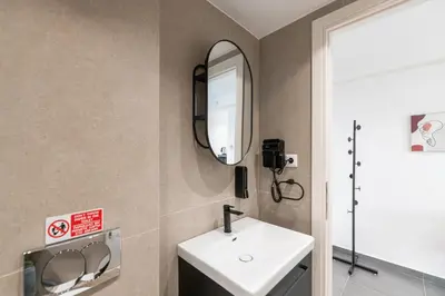 a bathroom with a sink and a mirror at South Metro Suite in Athens