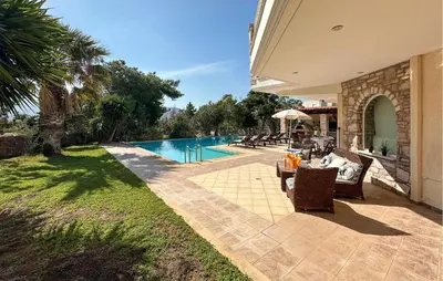 a house with a swimming pool in a yard at Gorgeous Home In Lagonisi With Wifi in Lagonissi
