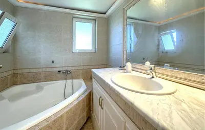 a bathroom with a sink and a tub and a mirror at Gorgeous Home In Lagonisi With Wifi in Lagonissi
